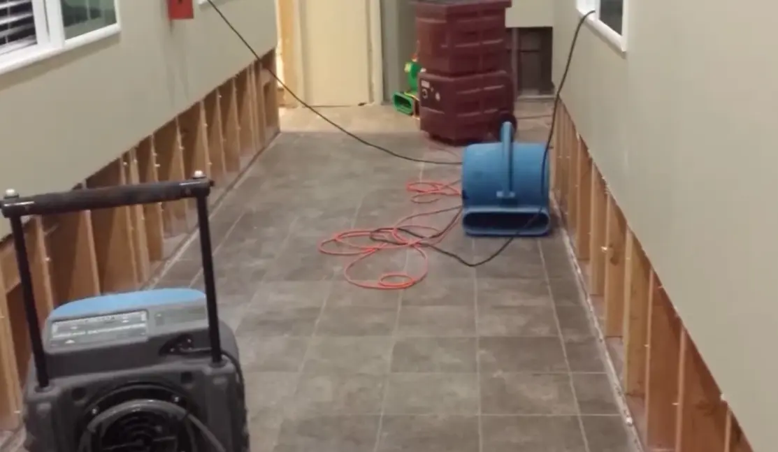 Homeowner documenting water damage before restoration begins