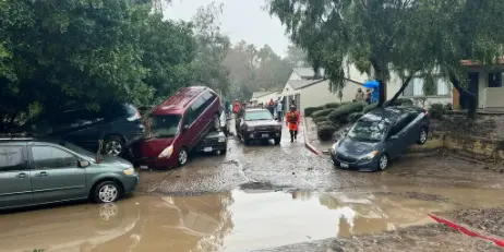 Flood damage restoration San Diego: flooded street and homes after heavy rain